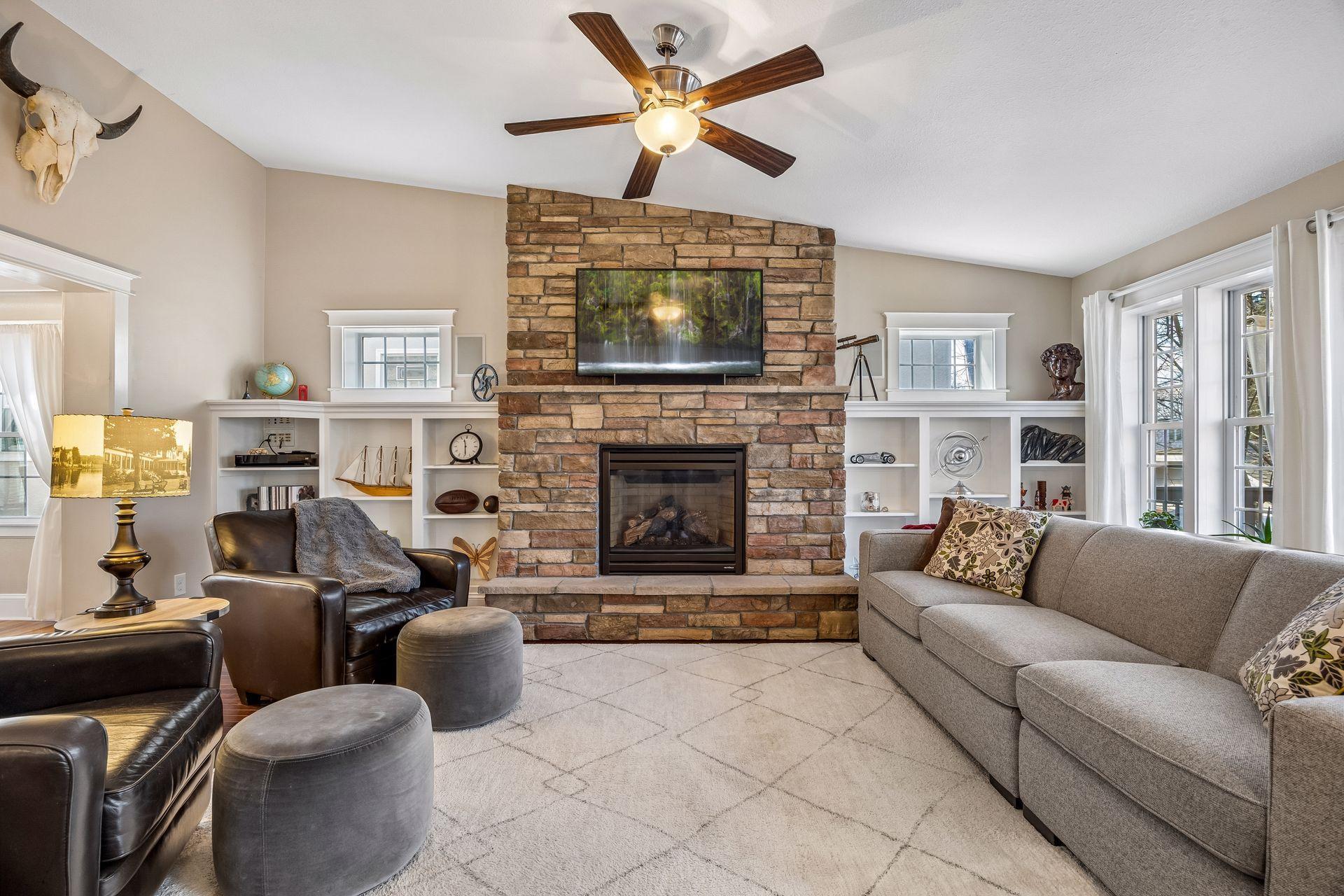 Enjoy the stone gas-burning fireplace flanked by built-in bookcases.