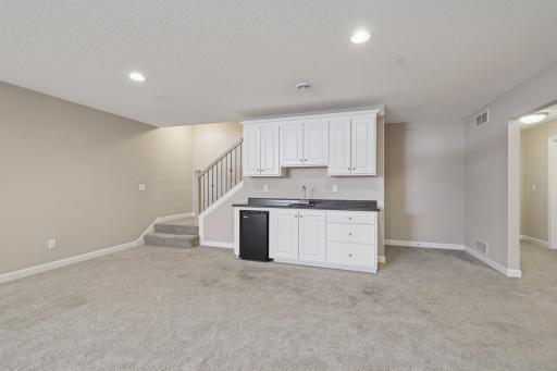 Built in bar area with sink and mini refrigerator