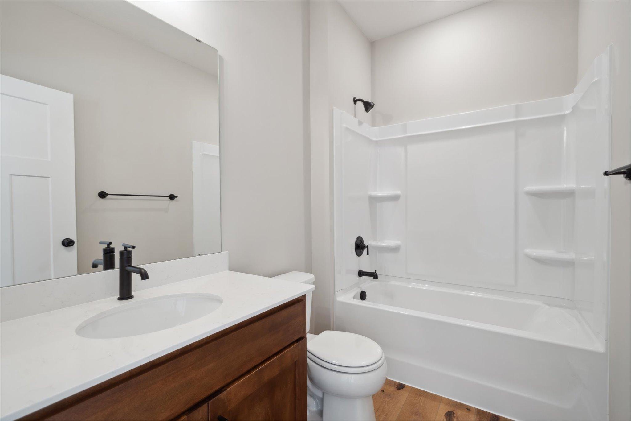 Main Level Bathroom *Photo of a previously built home of the same floor plan. Finishes/options may vary.