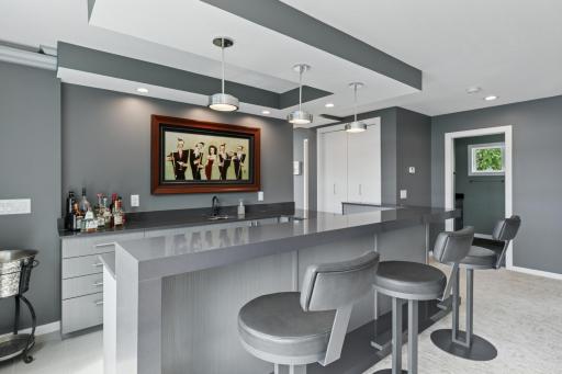 Main level bar area offers a built-in wine bar along with heated floors and countertops