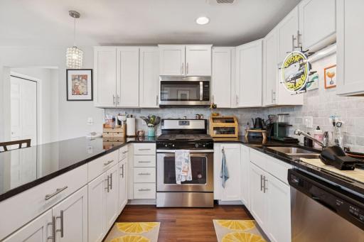 Gas range and microwave making cooking easy and enjoyable.