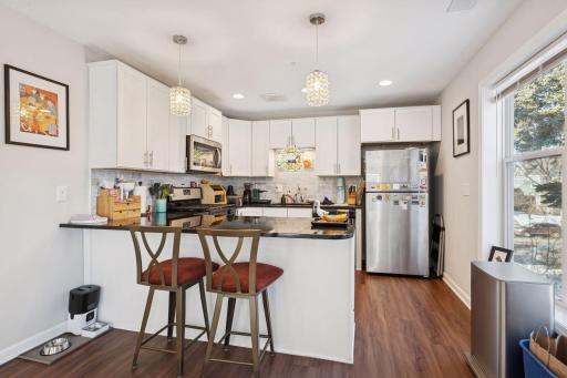 Kitchen with breakfast bar and stainless steel appliances.