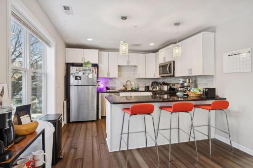 Unit two kitchen with breakfast bar and stainless appliances.