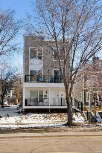 Fourplex with balconies and two units with rooftop patios.