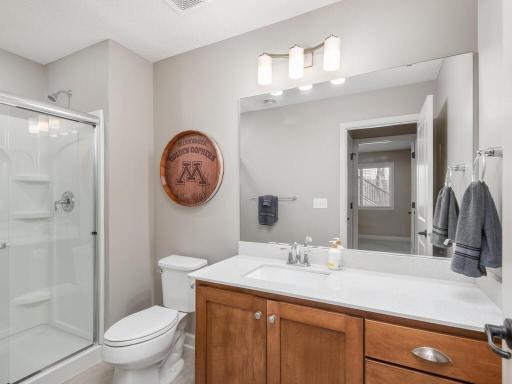 With modern fixtures & durable surfaces, the lower level bath combines style & practicality, ensuring comfort for guests & family alike. Convenient access to the pool, makes it perfect for changing and rinsing off after a swim.