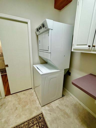 Laundry room with stackable washer/dryer. There is room for a side by side if the buyer wanted to install that