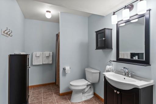 Conveniently located, a bathroom with tile flooring and a walk-in shower.