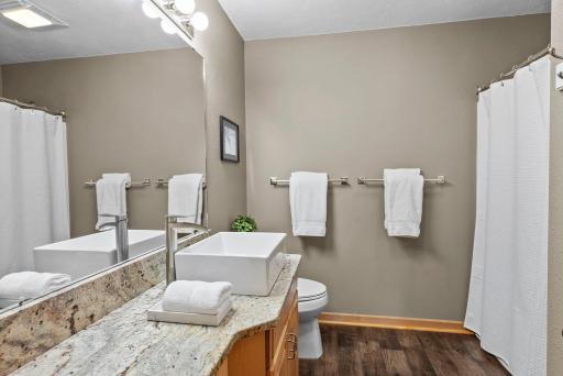 Large closets throughout the main level provide generous storage, and a nearby shared bathroom offers extended counter space and ample vanity storage. Main level laundry supports single level living, if desired.