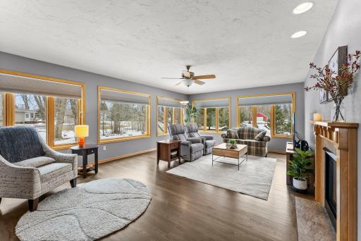 Just beyond, the large and welcoming family room enjoys multiple oversized windows and the opposite side of the gas fireplace, creating another inviting space for entertaining or unwinding.