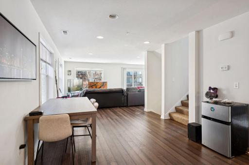 Unit 2 open concept dining, living and kitchen area. Stairway to upstairs and lower entry.