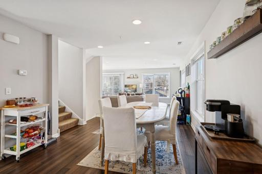 Open concept dining area. Stairways up to bedrooms and down to entryway.
