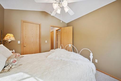 Secondary bedroom with vaulted ceiling and backyard view