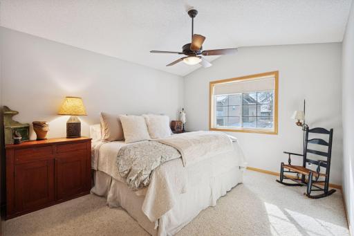 Owner's suite freshly painted throughout w/ vaulted ceiling, adjustable fan & dimmable light, large walk-in closet w/ pass thru w/ built-ins, granite counter, walk-in shower w/ tile surround & tile flooring, pass thru linen closet, toilet room & more