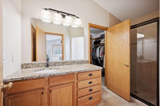 Owner's suite bathroom freshly painted and with new mirror. Linen closet custom pass-through to the hallway.