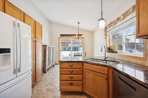 Custom cabinets and pantry with roller-drawers. Upgraded kitchen countertop and fixtures.