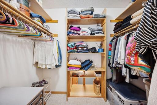 Owner's suite closet with custom built ins, pass-through for laundry to the main floor laundry room.