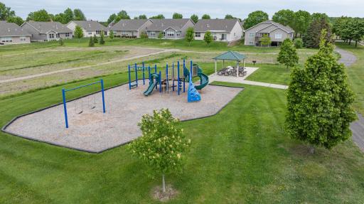 Neighborhood Park across the street with pavilion, picnic tables, playground, and trails.