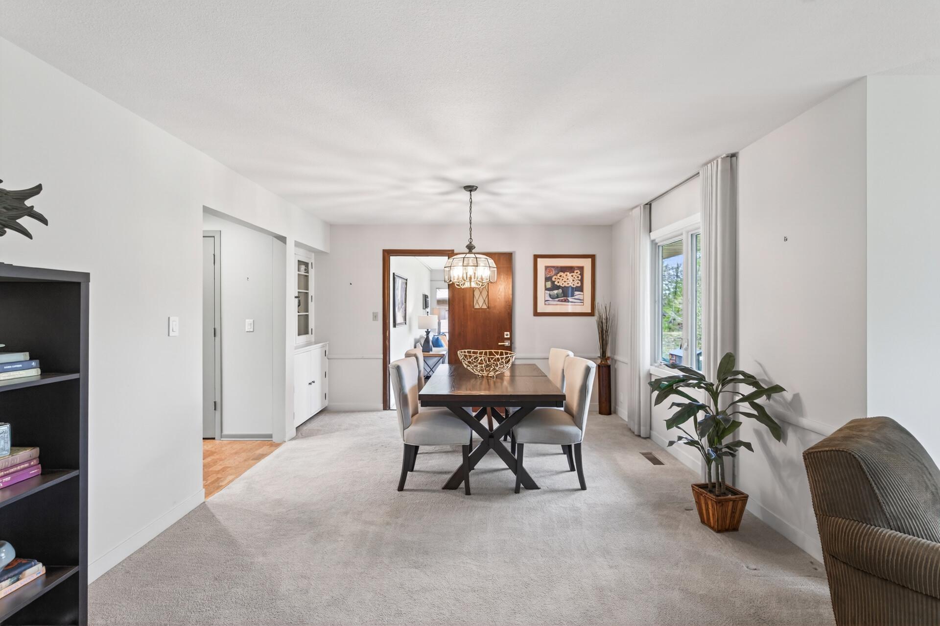 Main floor dining room has a built-in cabinet and access to the 3 season porch with an A/C unit