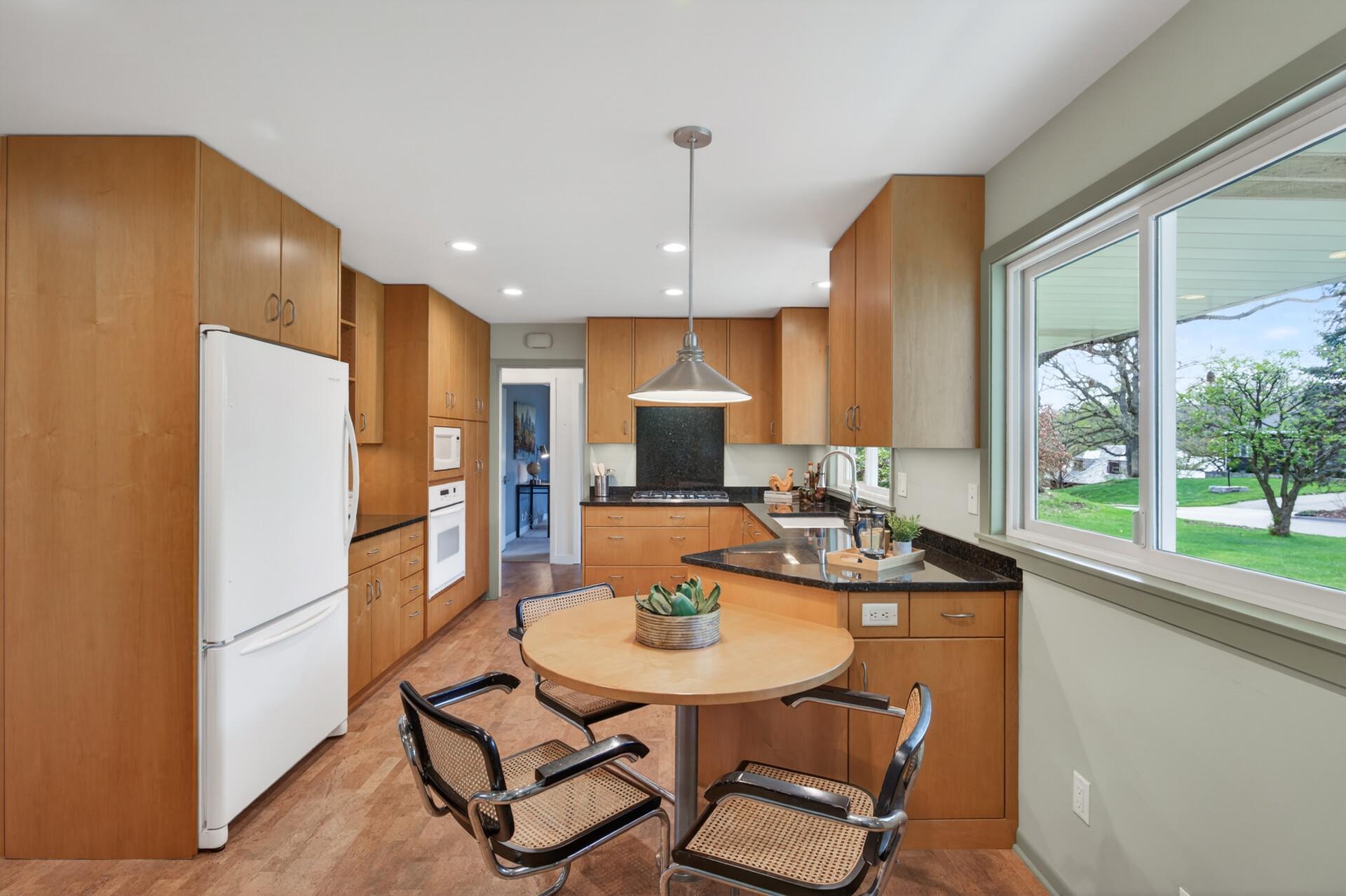Kitchen has a built-in table for informal dining