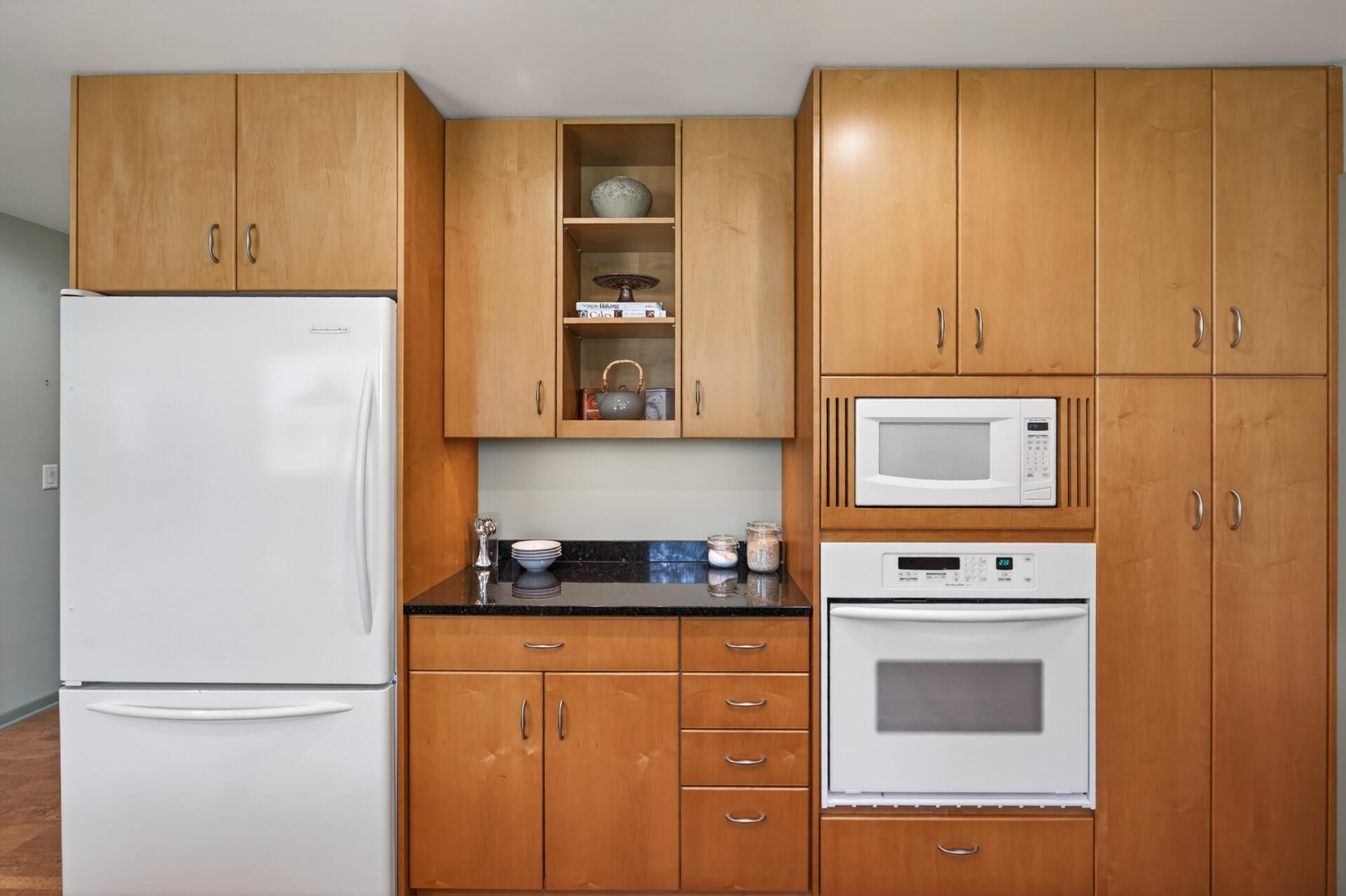 Maple cabinetry, granite counters, wall oven, built-in microwave and plenty of storage