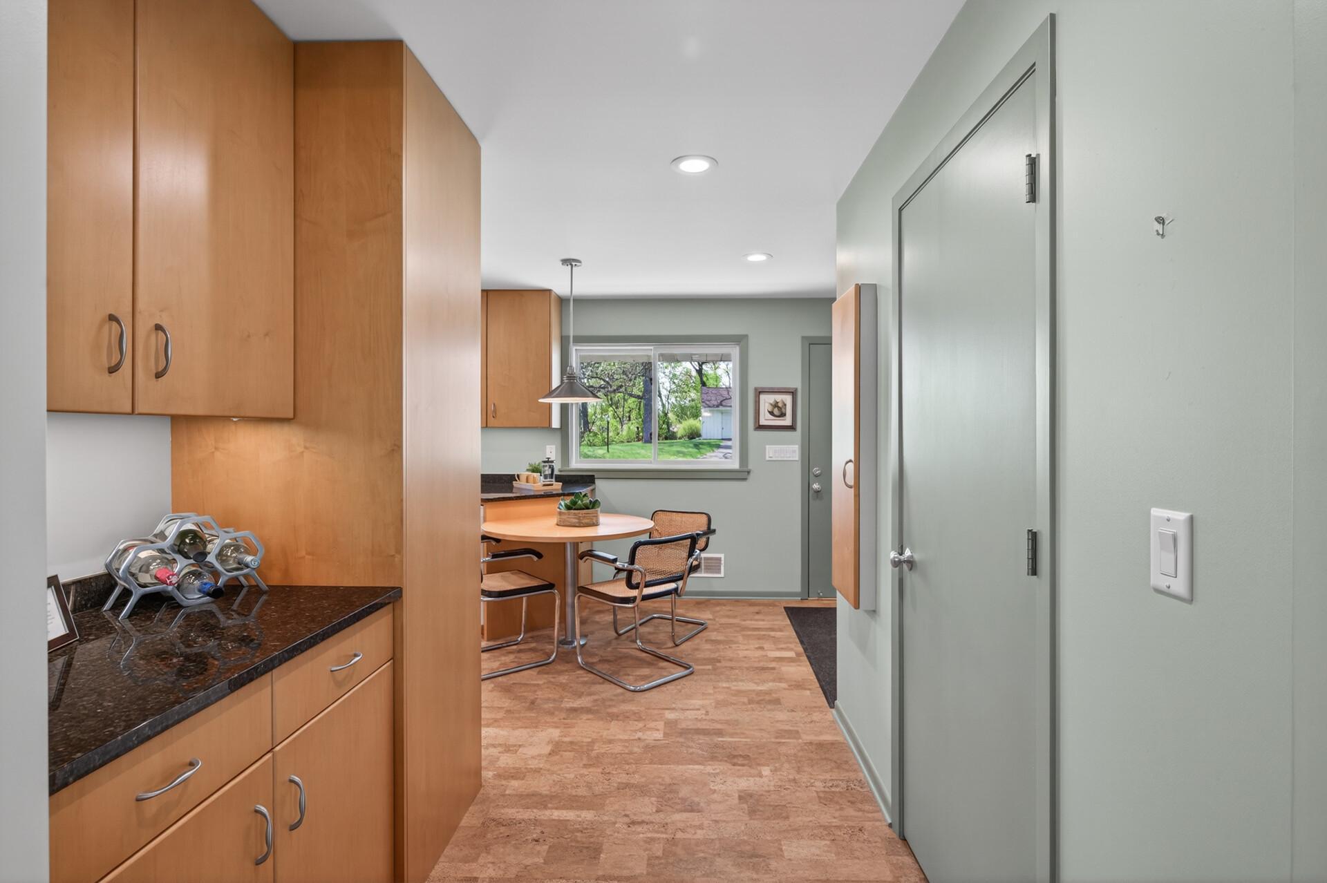 Butler's pantry convenient for entertaining. The door on the right opens to the main floor washer & dryer (there is a separate laundry room in the lower level). Also included in a built-in ironing board.