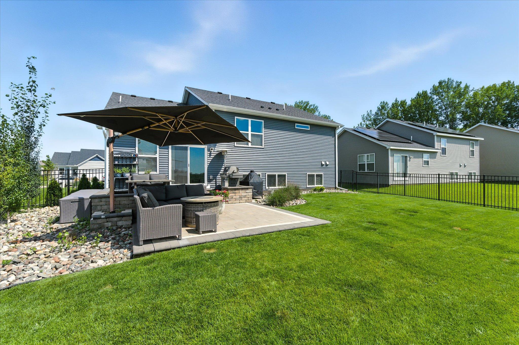 Large fenced in yard with wrought iron fencing