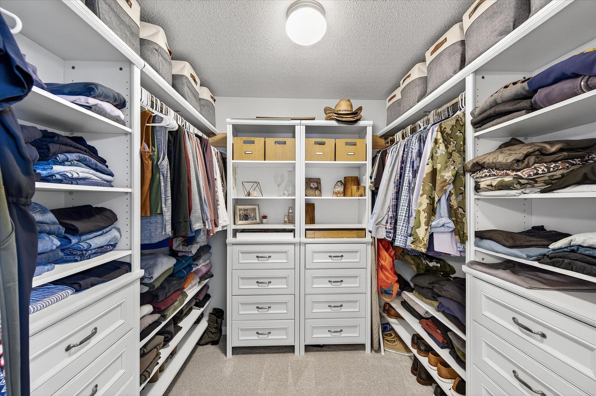 Lovely primary walk in closet with built in's