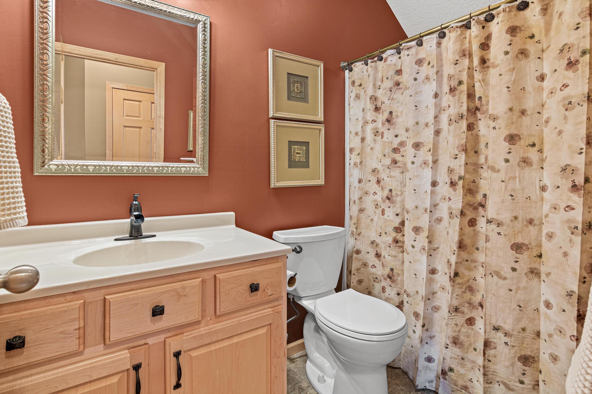 The main floor full bathroom received a glow up in recent years as well. Updates include new flooring, new hardware on the vanity cabinet and the toilet flush handle, and updated lighting!