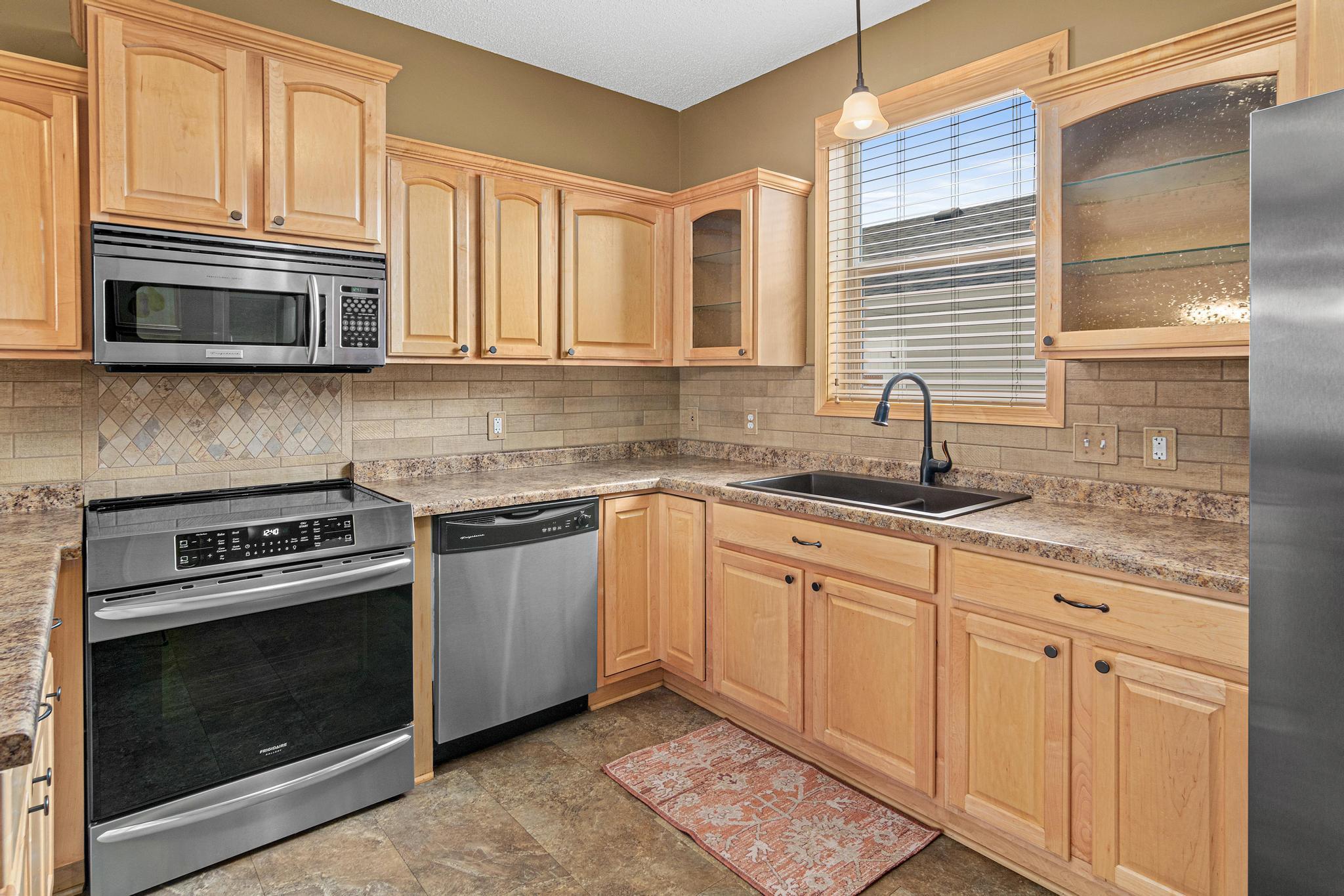 The seller also installed a stylish backsplash, new sink, new faucet, updated lighting and new hardware on all of the cabinets.