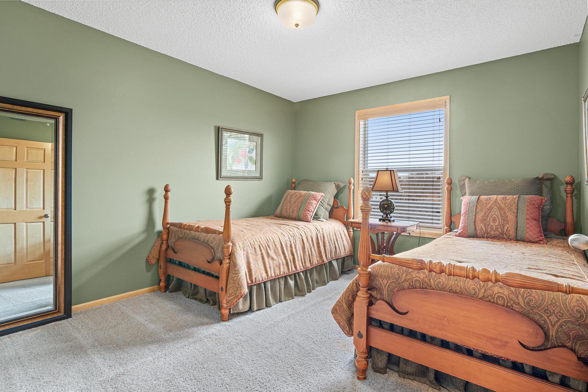 Bedroom 2 of 3 on the upper level has an especially large walk-in closet for a supporting bedroom.