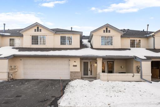 Attached garage with asphalt driveway and garage door opener.