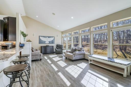 Living room off of the kitchen with beautiful windows looking out to the woods