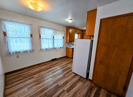 Entry from garage into house front dining area with new vinyl plank flooring installed 2022 and right(door to basement)