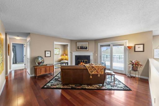 The living room with its cozy woodburning fireplace is the heart of the home.