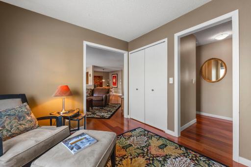 The den opens to both the living room and the hallway.