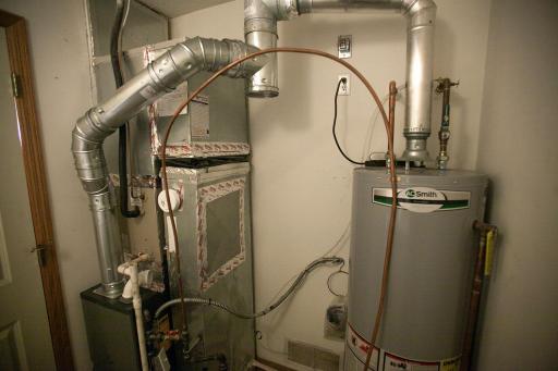 Mechanical room with new furnace (2026), water heater (2022) and water softener (2020).