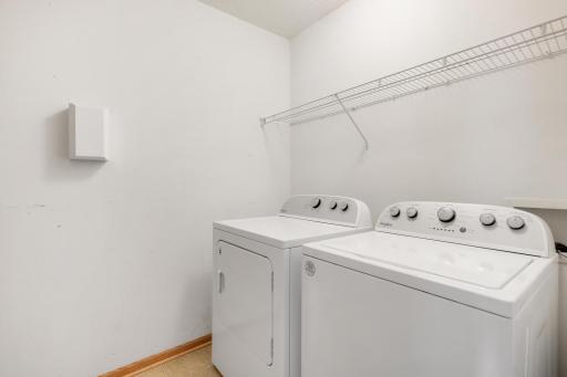 Separate laundry room with new washer and dryer in 2023.