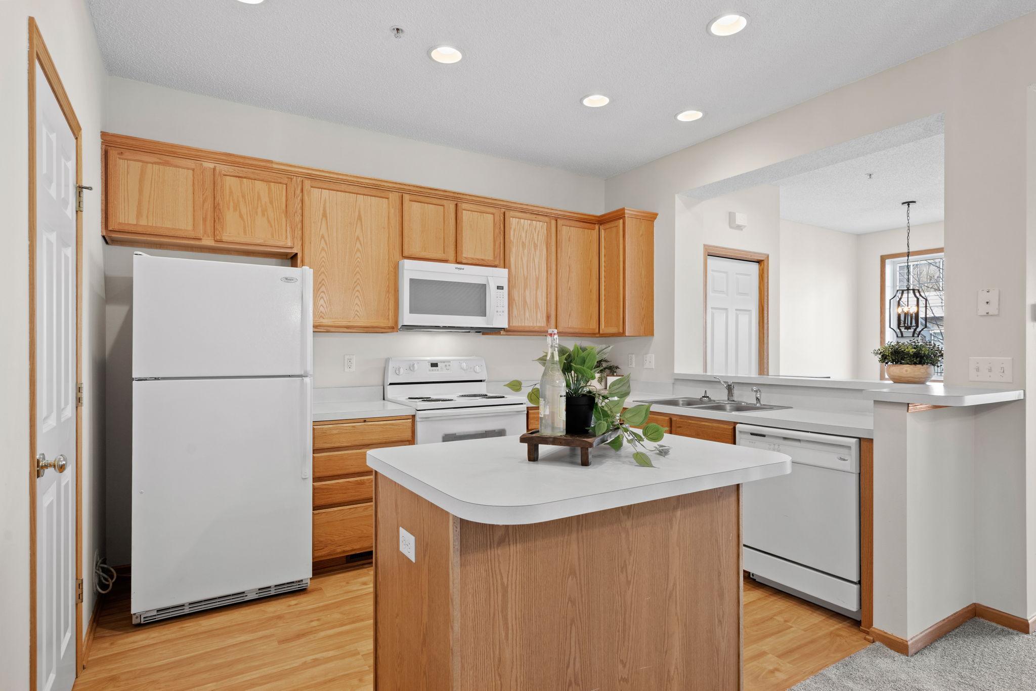 Kitchen features an "eat-in" island and lots of cabinet storage