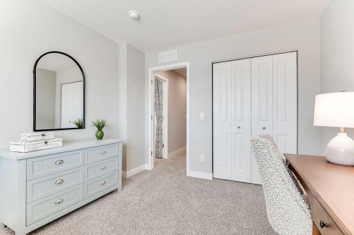 One of 4 spacious upper level bedrooms. Photo of model home, color & options will vary.