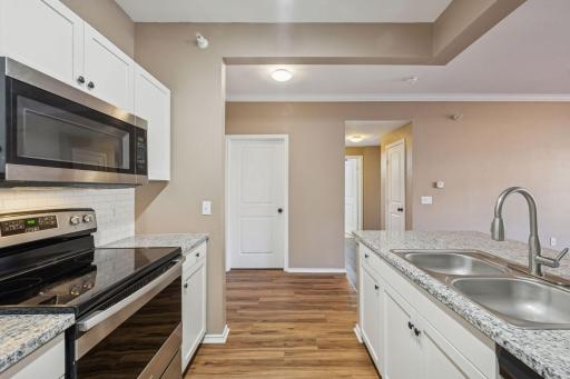 Freshly renovated kitchen with new countertops, backsplash, flooring, and fixtures