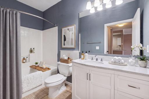 Updated vanity with marble-look counters, soaking tub & spa-inspired finishes. Your daily reset, built in. *virtually staged