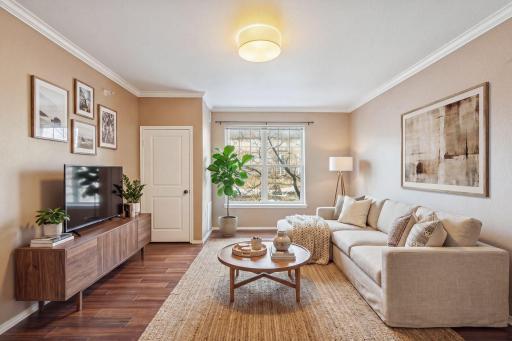 Crown molding, hardwood-style floors & natural light make this living room feel bigger than the square footage suggests. *virtually staged for inspiration!