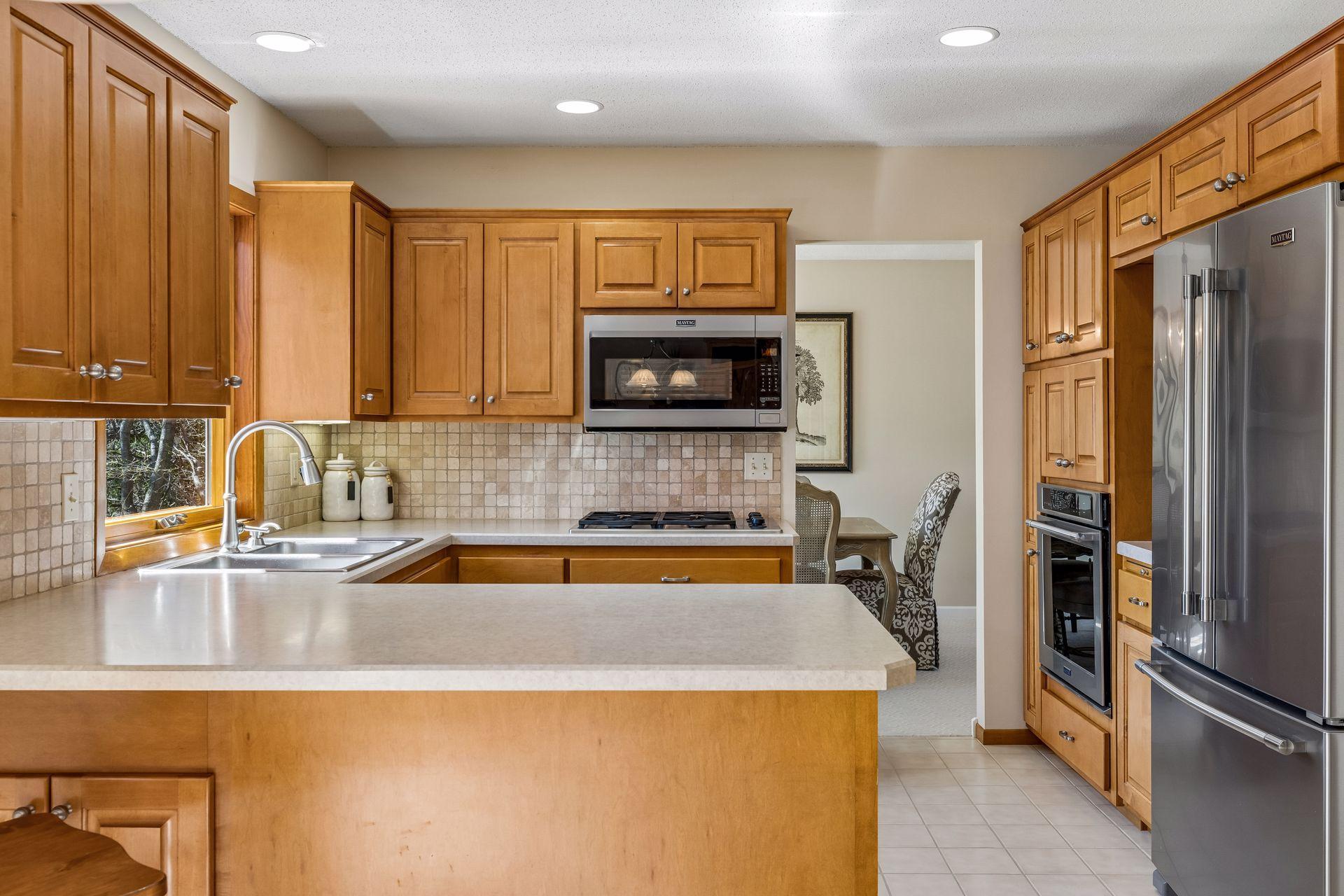 Light and bright kitchen with stainless steel appliances
