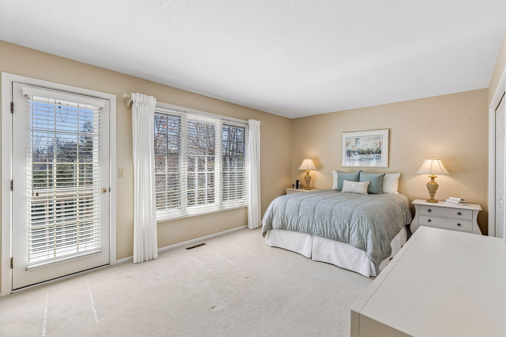 Upper level Owner's bedroom includes quaint balcony with views of pretty back yard.