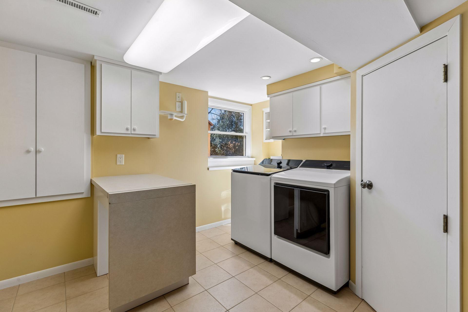 Cheerful and bright laundry ~ washer, dryer, sink and access to great storage area