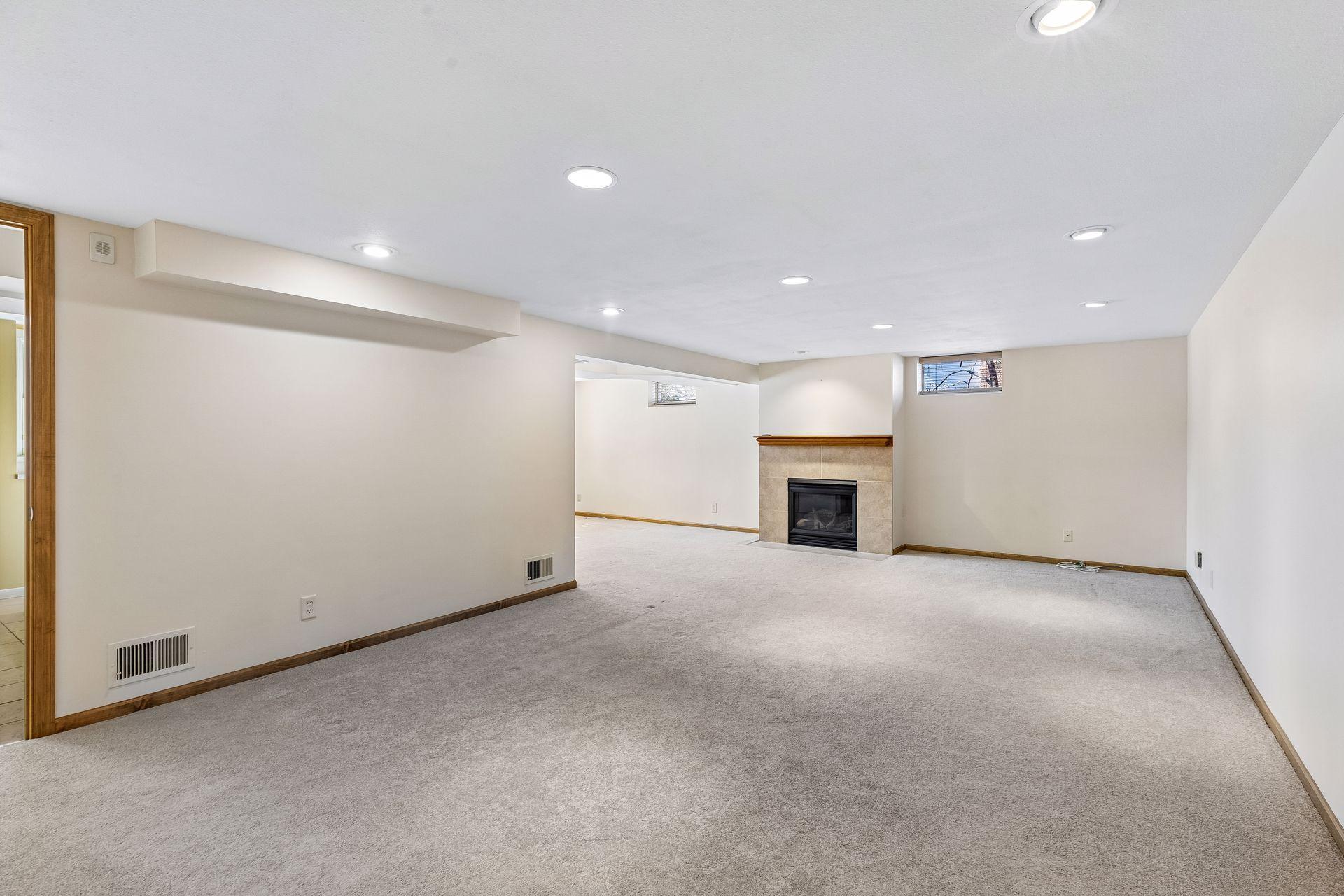 The lower level features a large amusement room with gas fireplace