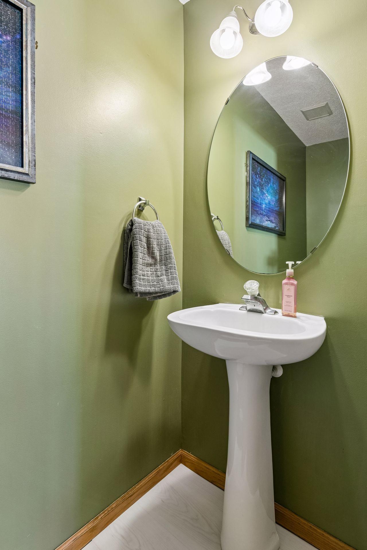 Handy 1/2 bath on the main level located at end of kitchen & just off of garage entrance.