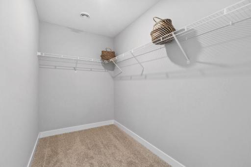 Huge walk-in closet in primary bedroom. Photo of Model home. Colors and options may vary. Ask Sales Agent for details.