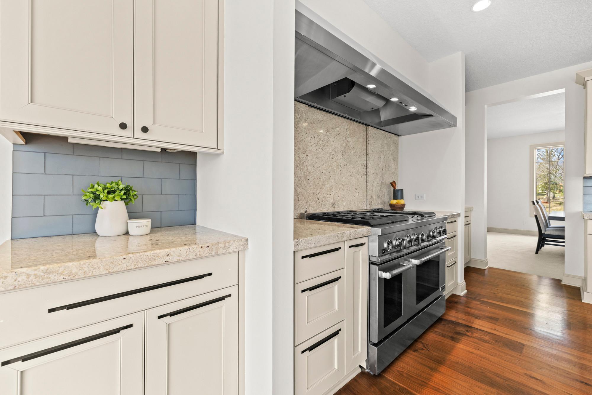 Rolling granite behind the range hides the spice racks