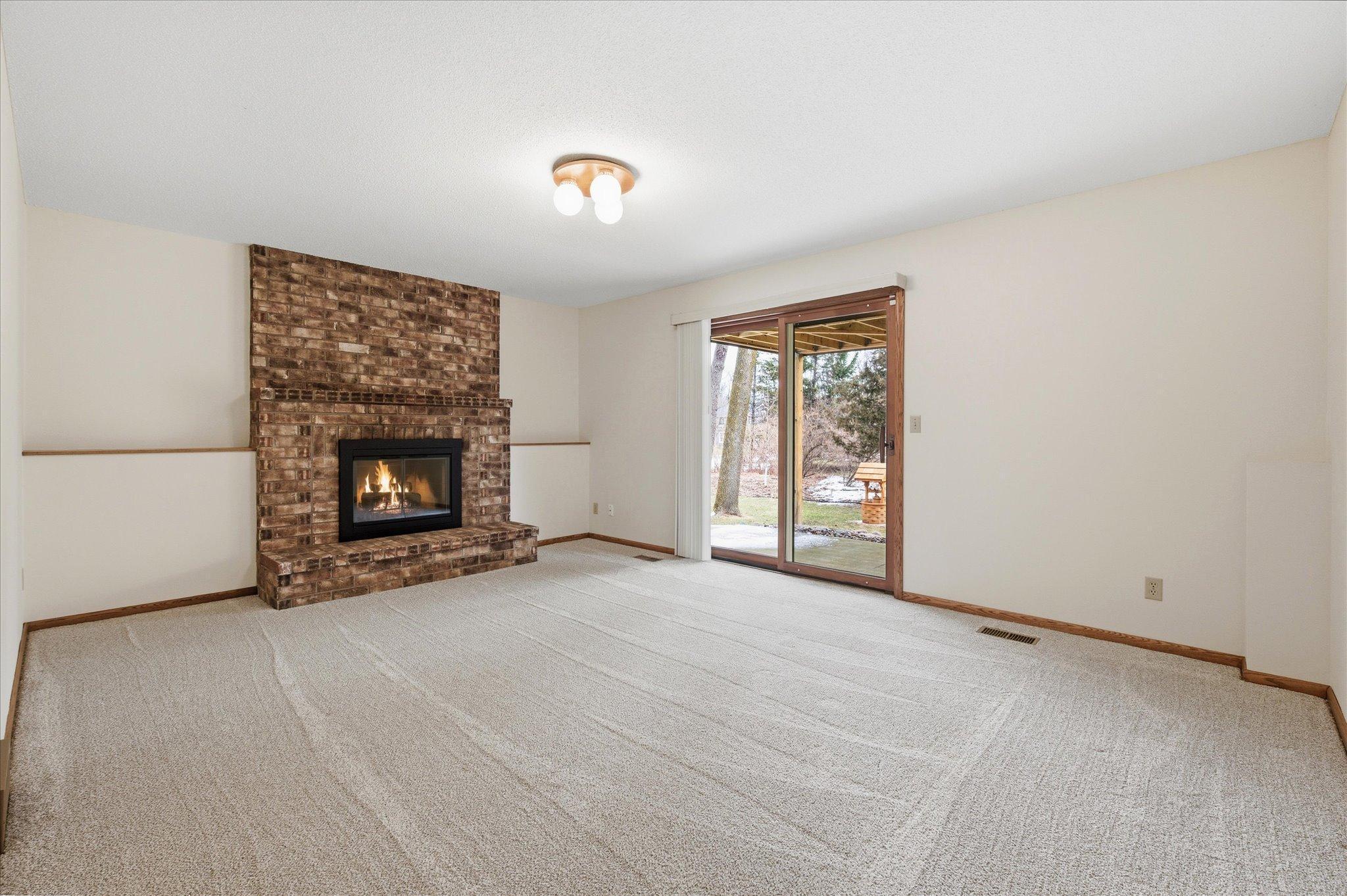 Lower level Family Room with wood burning fireplace